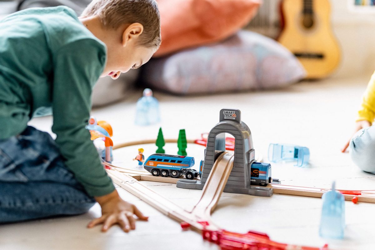 Kids playing with Brio Train on the floor