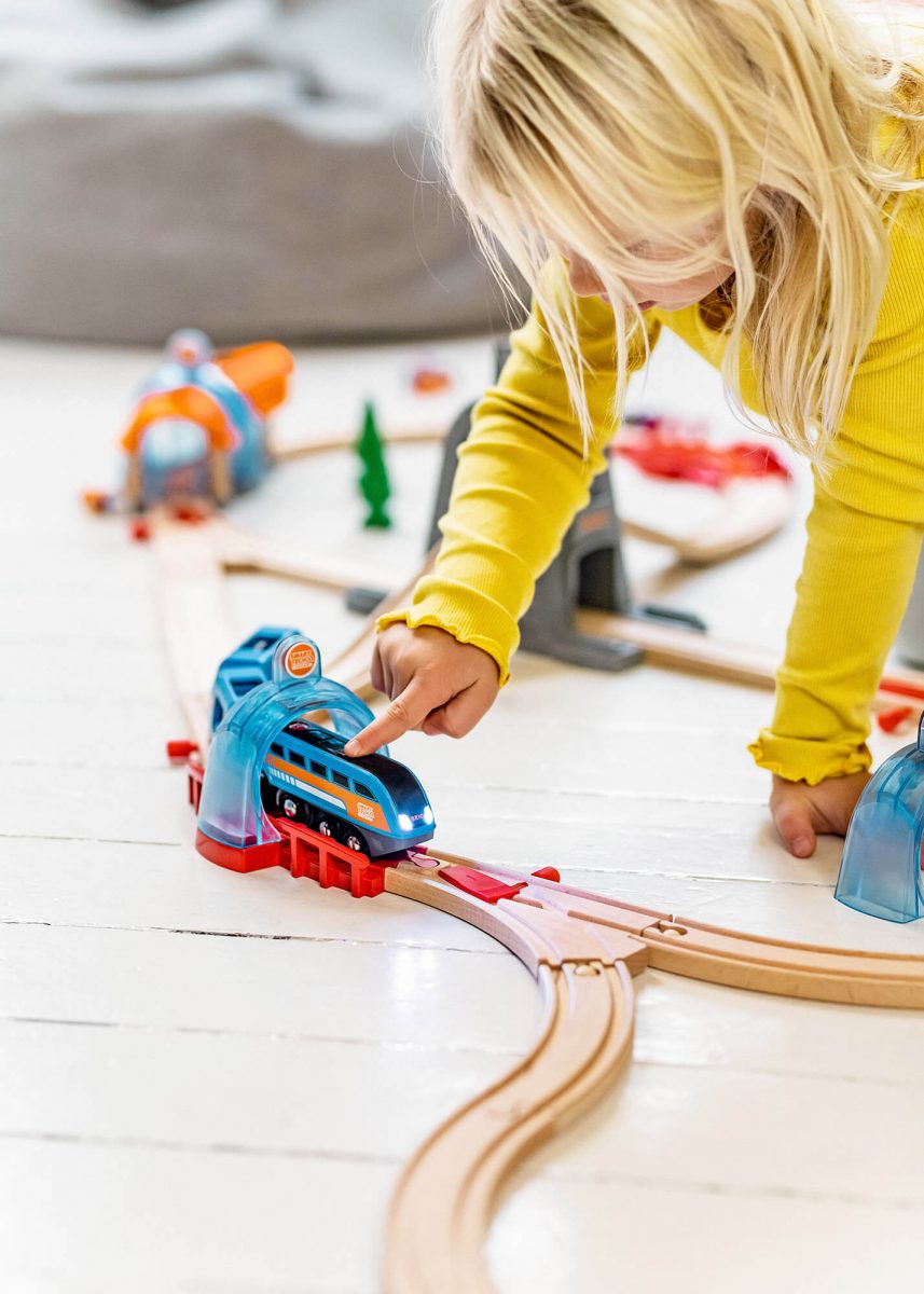 Brio, Kid playing on floor with Brio Train